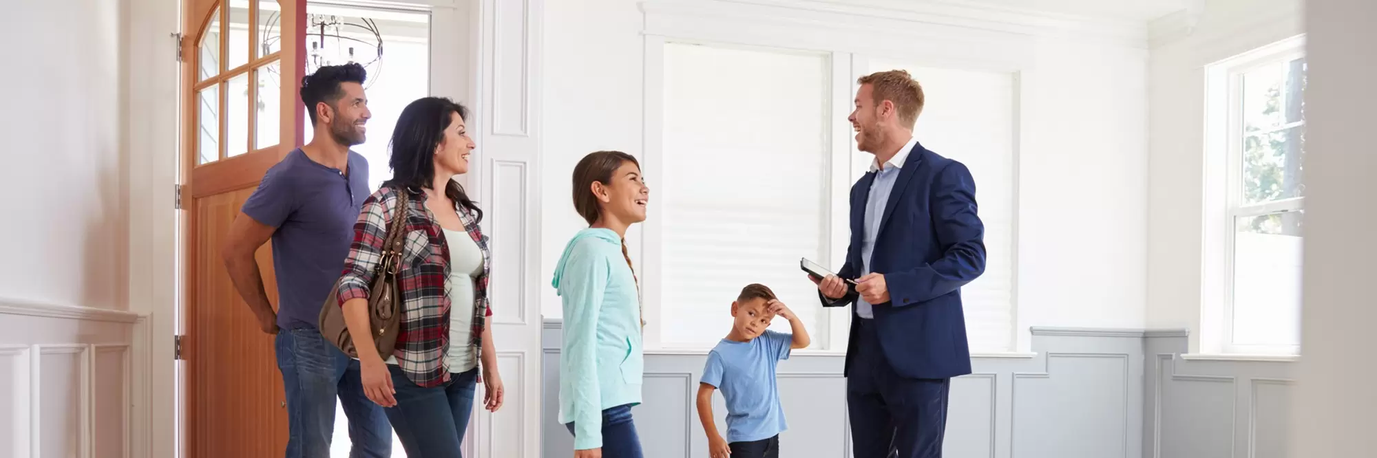 Realtor Showing Hispanic Family Around New Home